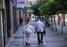 Una pareja de ancianos pasea por las calles de Vitoria-Gasteiz.