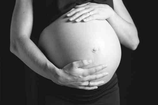 Mujer embarazada posa en una foto de estudio