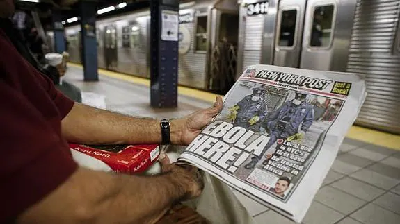Un neoyorquino leyendo la prensa que habla del ébola. 