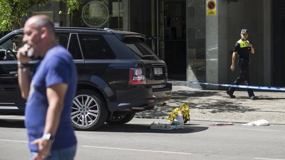 Un agente observa el lugar en el que el hombre intentó suicidarse tras disparar a su pareja. 