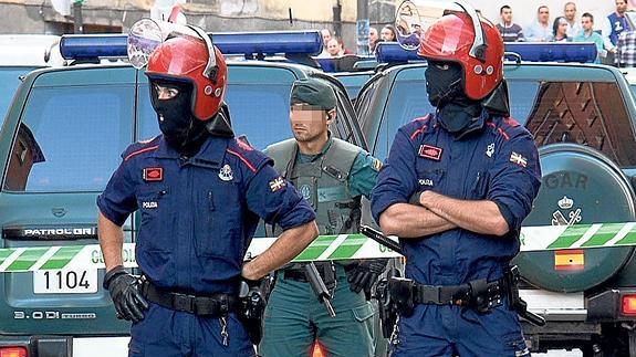 Una imagen poco frecuente, agentes de la Ertzaintza y un guardia civil en una operación conjunta desarrollada en un barrio de Bilbao.