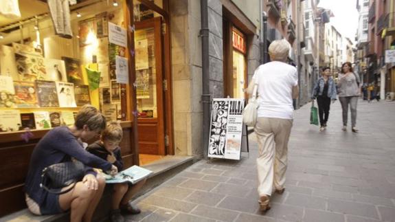 Paseantes y clientes en la Correría, la animada arteria comercial del barrio medieval.