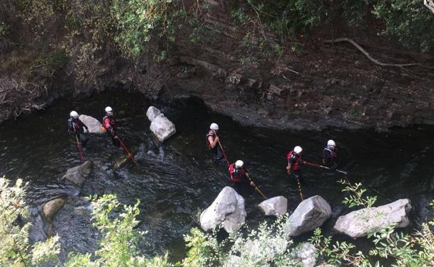 Efectivos de Emergencias buscan en el río Quiviesa. 