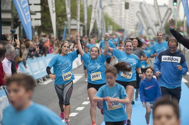 Un grupo de mujeres cruza la meta de la Carrera Popular de El Diario.