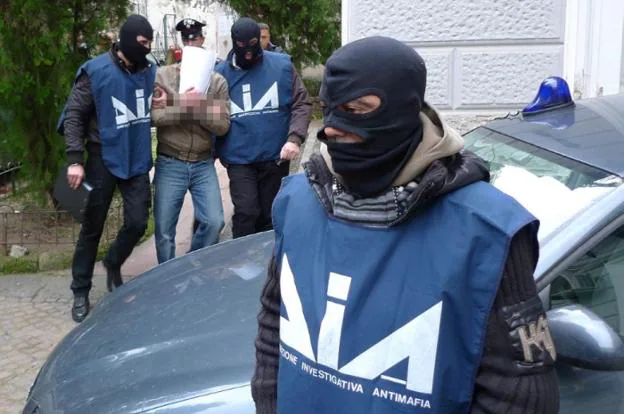 Operativo contra la 'Ndrangheta. Agentes del cuerpo especial contra la mafia detienen a un sospechoso.