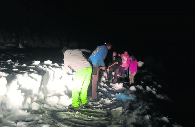 Los vecinos, intentando retirar la nieve de la calzada a paladas el pasado lunes. 