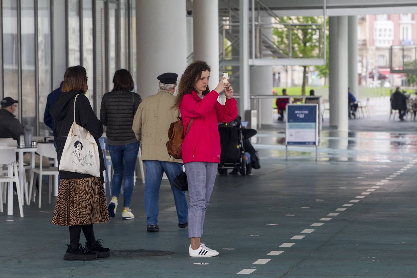 Imágenes de turistas paseando por Santander este lluvioso Jueves Santo