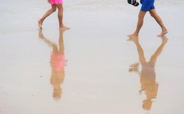 Dos personas caminan por El Sardinero.