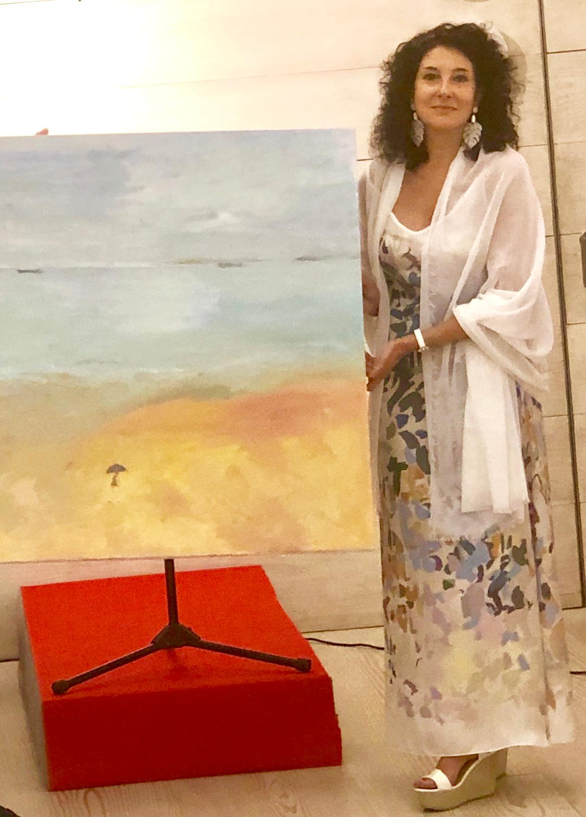 Iza junto al cuadro que ha donado a Rosa Navidad para el sorteo benéfico en apoyo a la Asociación Española Contra el Cáncer (AECC).