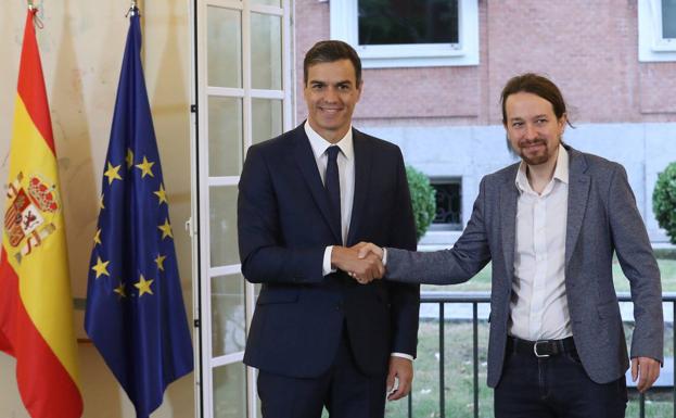 Sánchez e Iglesias se estrechan la mano antes de rubricar el acuerdo de Presupuestos en 2018.