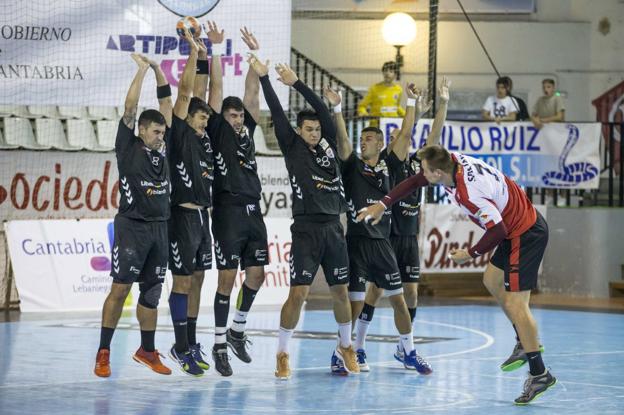 Los jugadores del Liberbank Cantabria Sinfín defienden un lanzamiento de falta en el partido en La Albericia ante el Puerto Sagunto. 