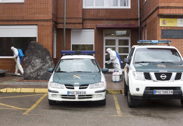 Dos operarios desinfectan el cuartel de la Guardia Civil de Santoña. celedonio