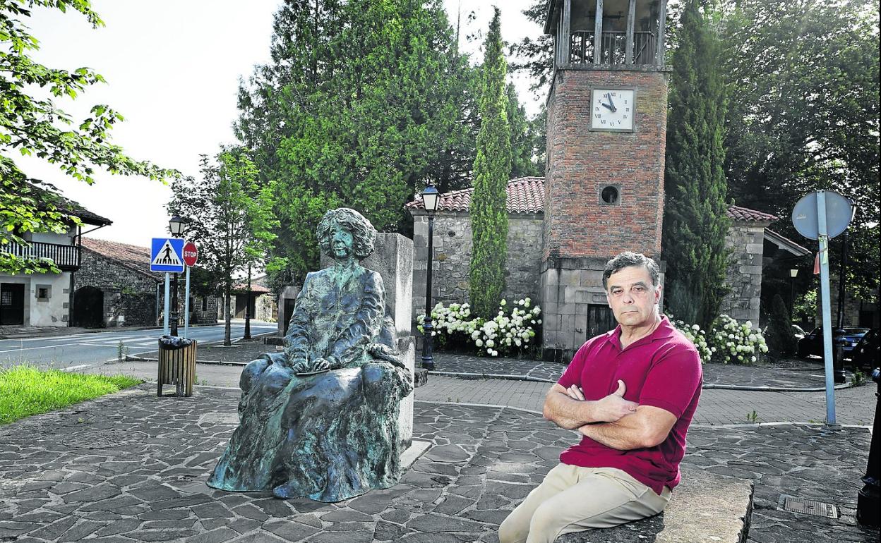 Íñigo Muguerza posa junto a la estatua de su bisabuela, la escritora Concha Espina, y un cuadro de su primera dedicatoria.