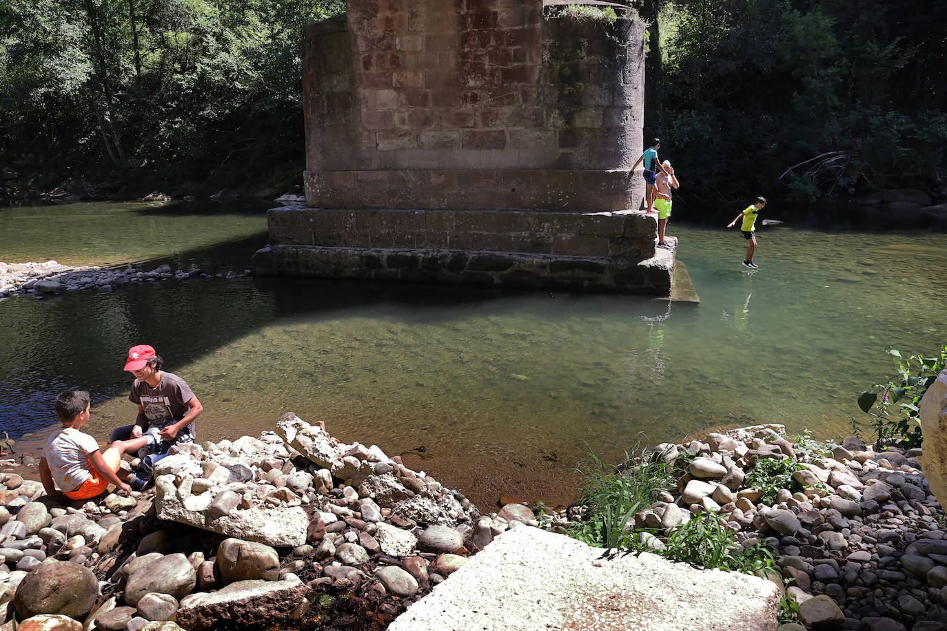 Los cauces y pozos son más que nunca un reclamo para los turistas estos días de calor, unos espacios que comparten con los vecinos. En estas imágenes, niños y mayores disfrutan en el río Saja, en el parque de Santa Lucía de Cabezón de la Sal.