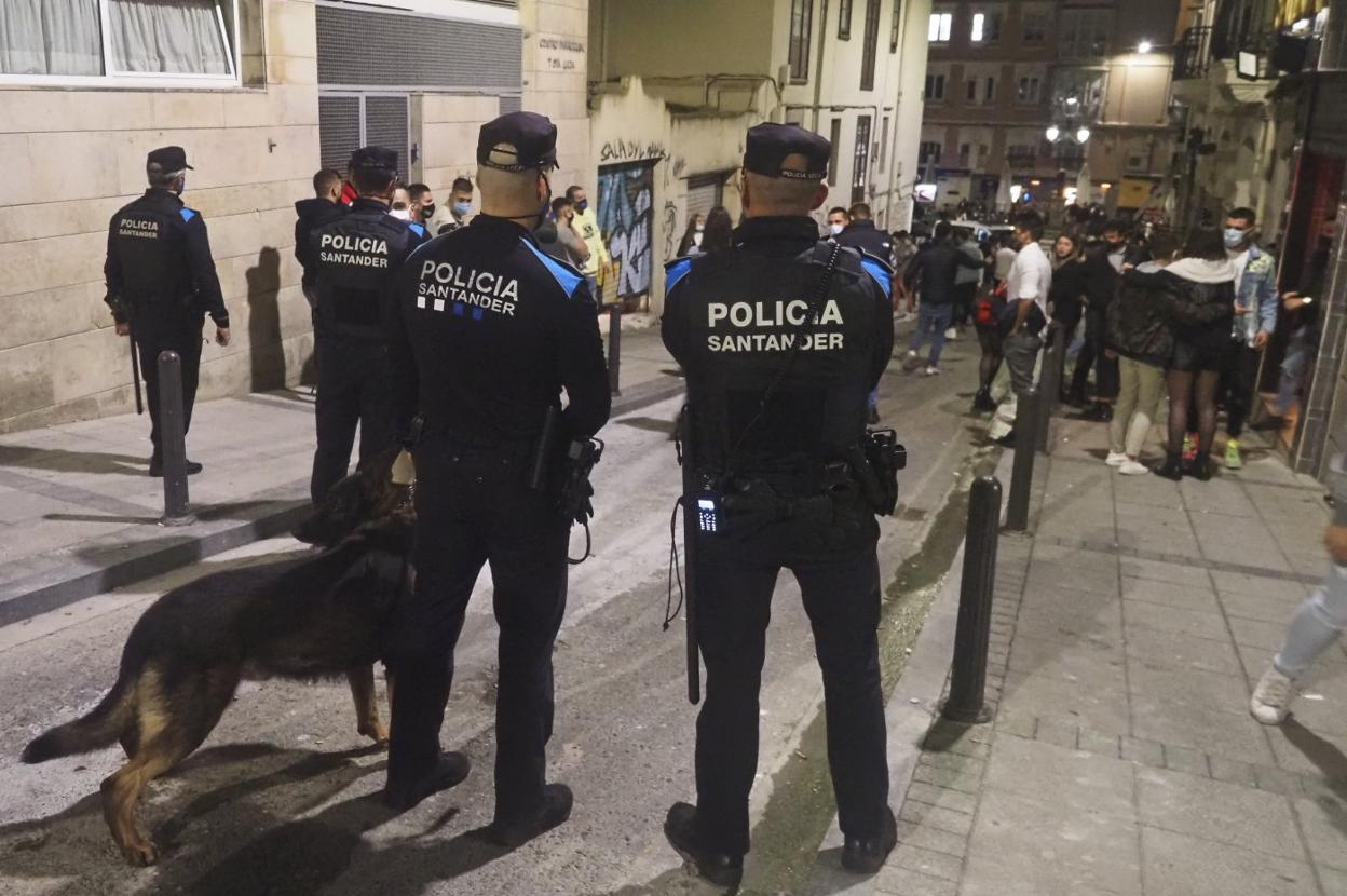 Cuatro agentes de la Policía Local de Santander, el viernes por la noche, dispersan grupos de jóvenes en el entorno de Cañadío tras el cierre de los bares.