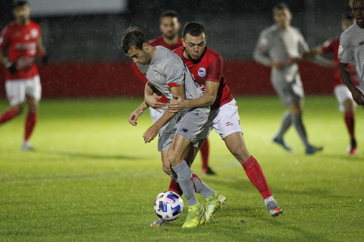 Saúl agarra a un jugador del Bilbao Athletic. 