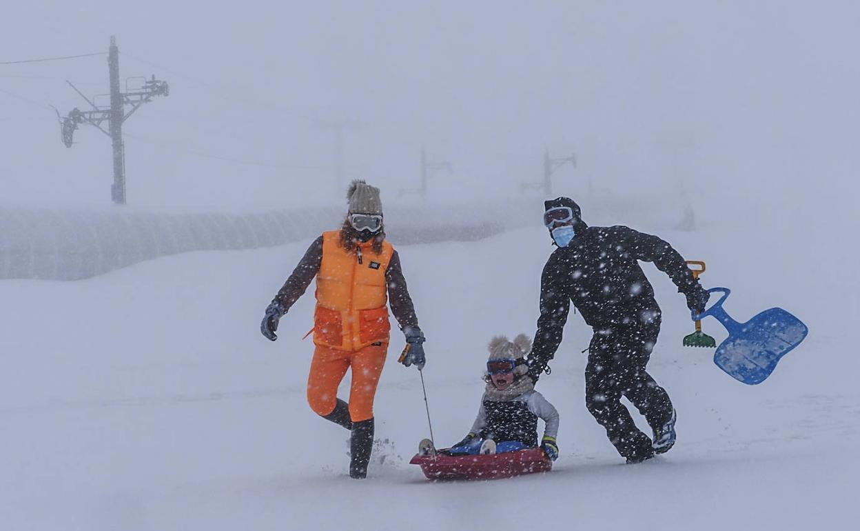 Una familia juega en la nieve en Alto Campoo.