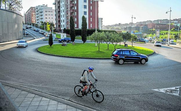 Un ciclista sale de la rotonda siuada en la intersección con Ernest Lluch. 