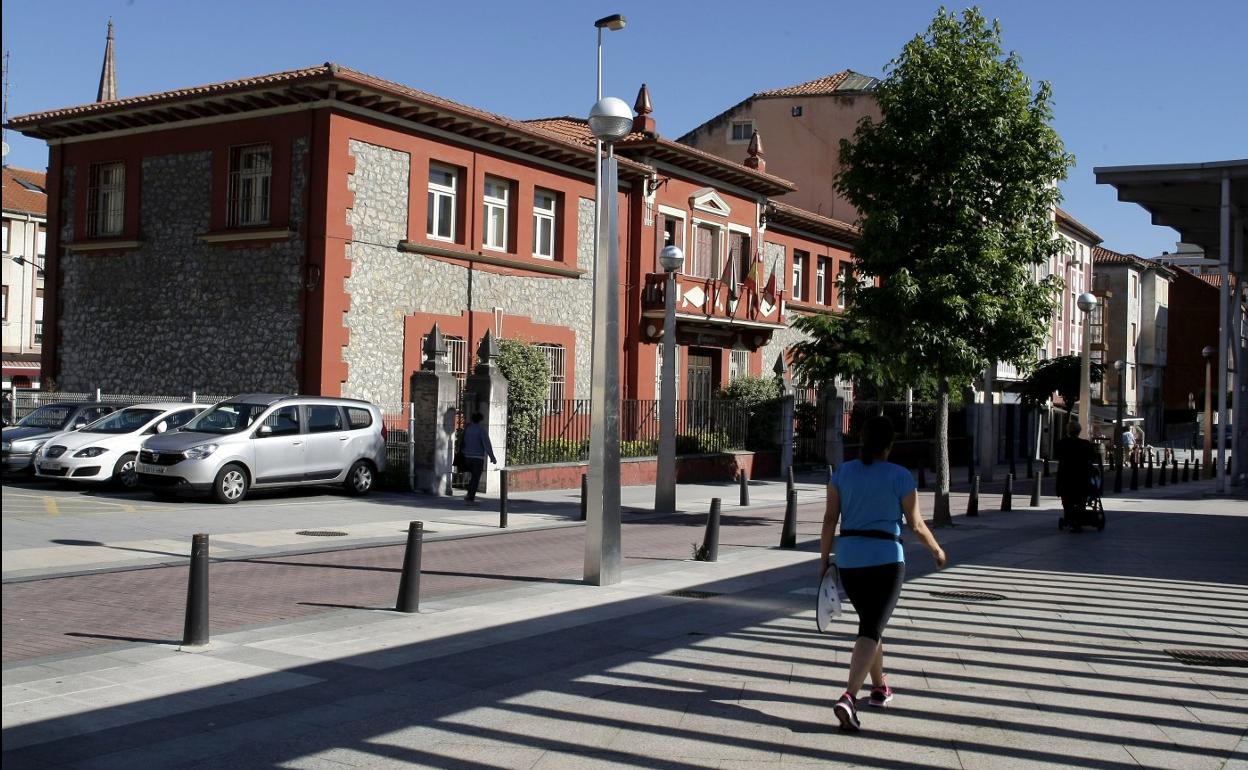 Una mujer camina frente al antiguo edificio de la Cámara en La Llama, adquirido por el Ayuntamiento. 