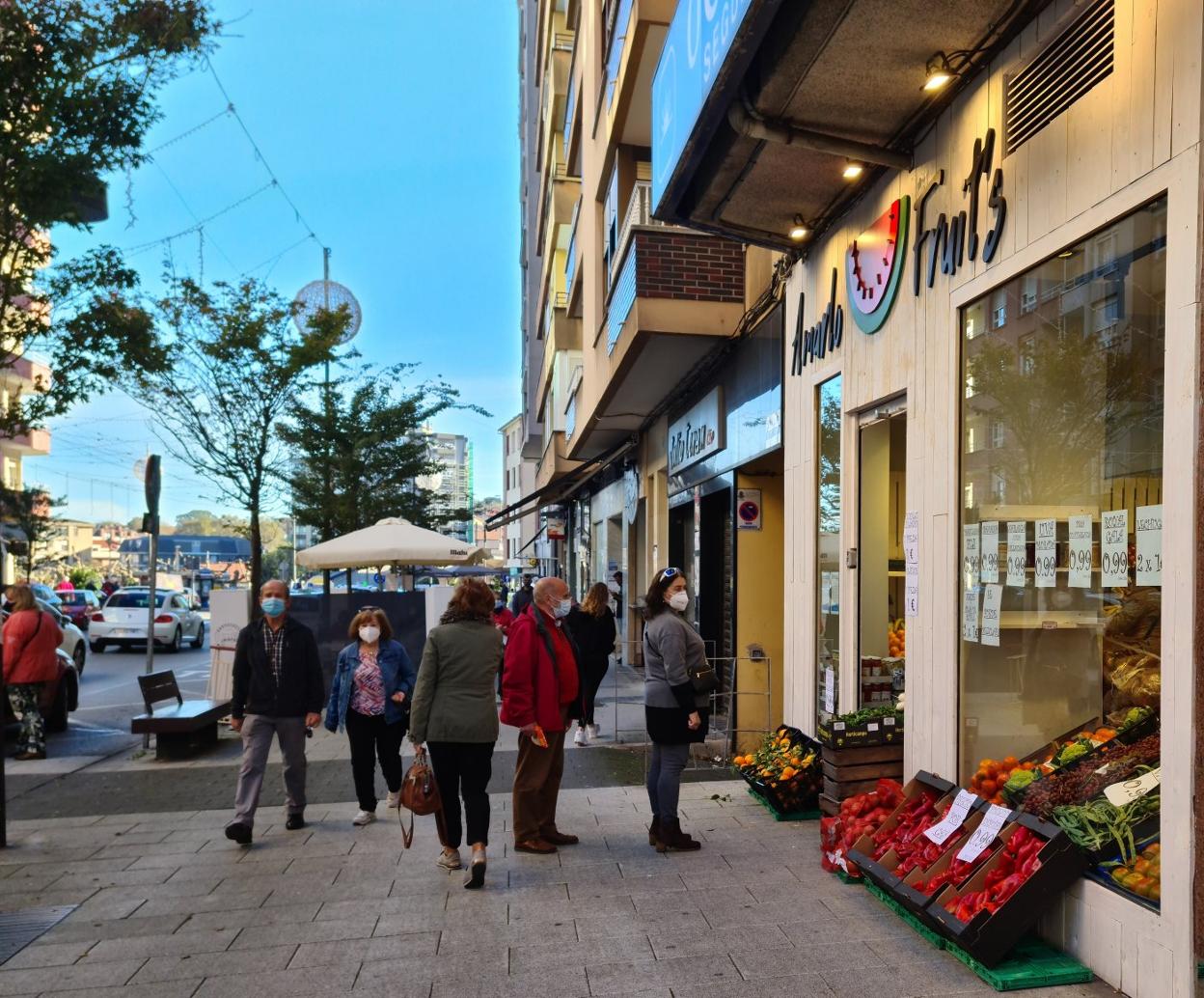 Vecinos de Camargo se detienen ante un escaparate, el pasado otoño, en el casco urbano de Muriedas.