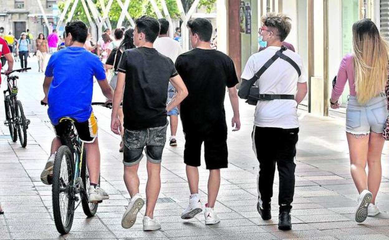 Un grupo de jóvenes pasea por la calle. 