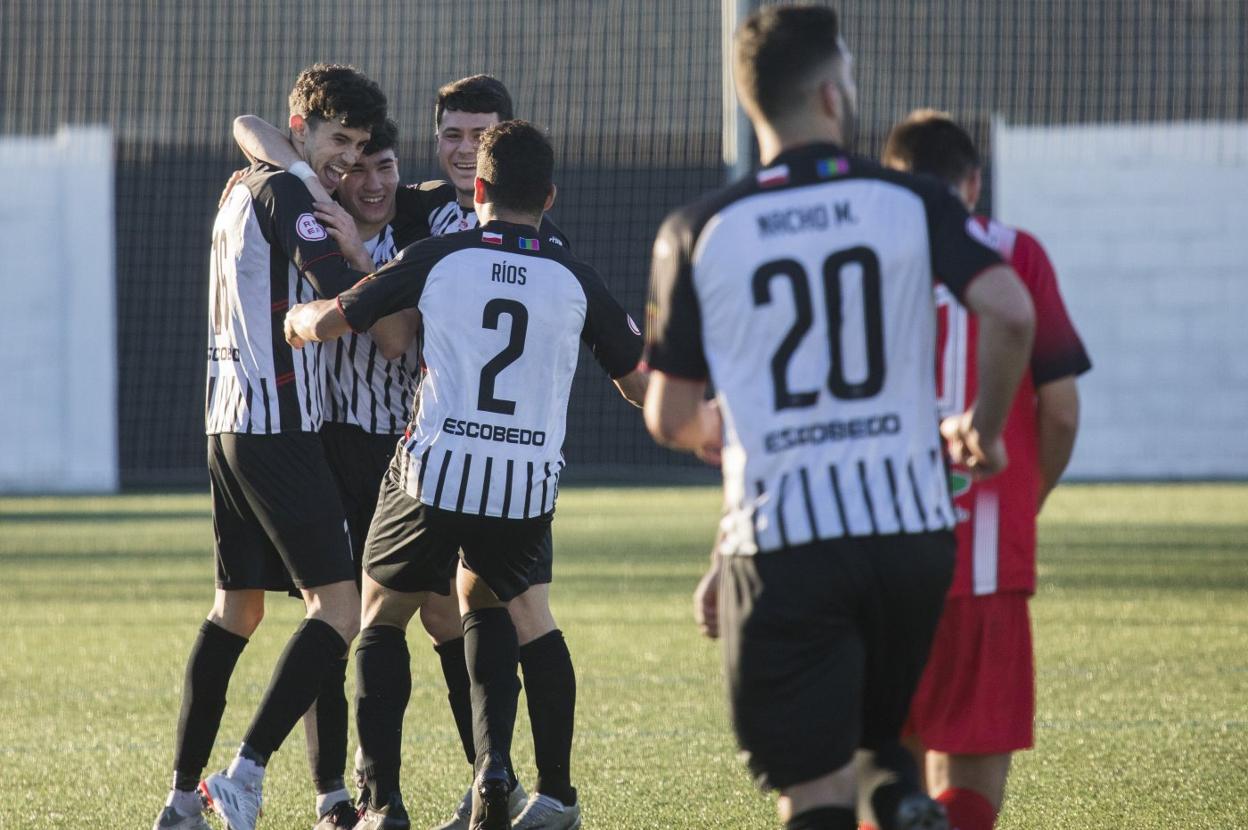 Los futbolistas del Escobedo celebran uno de sus tres tantos. 