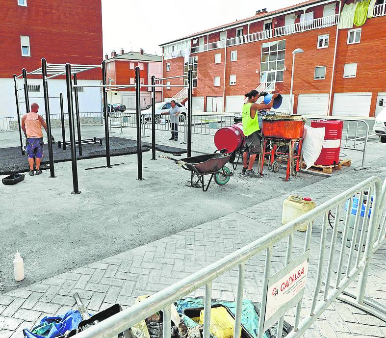 Operarios trabajan en el parque de calistenia.