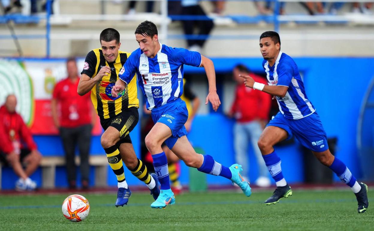 Carlos Álvarez, del Naval, conduce el balón ante Pablo Bolado, del Cayón, en un partido de Copa Federación.