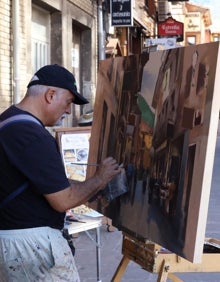 Imagen secundaria 2 - Galardonados, jurado y autoridades; cuadros premiados, y pintando en las calles de Potes 