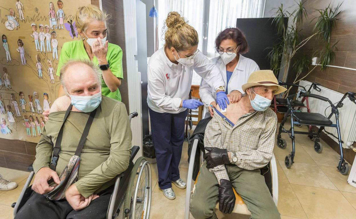 Personal de la residencia acompaña a los sanitarios del SCS mientras vacunan a los internos.