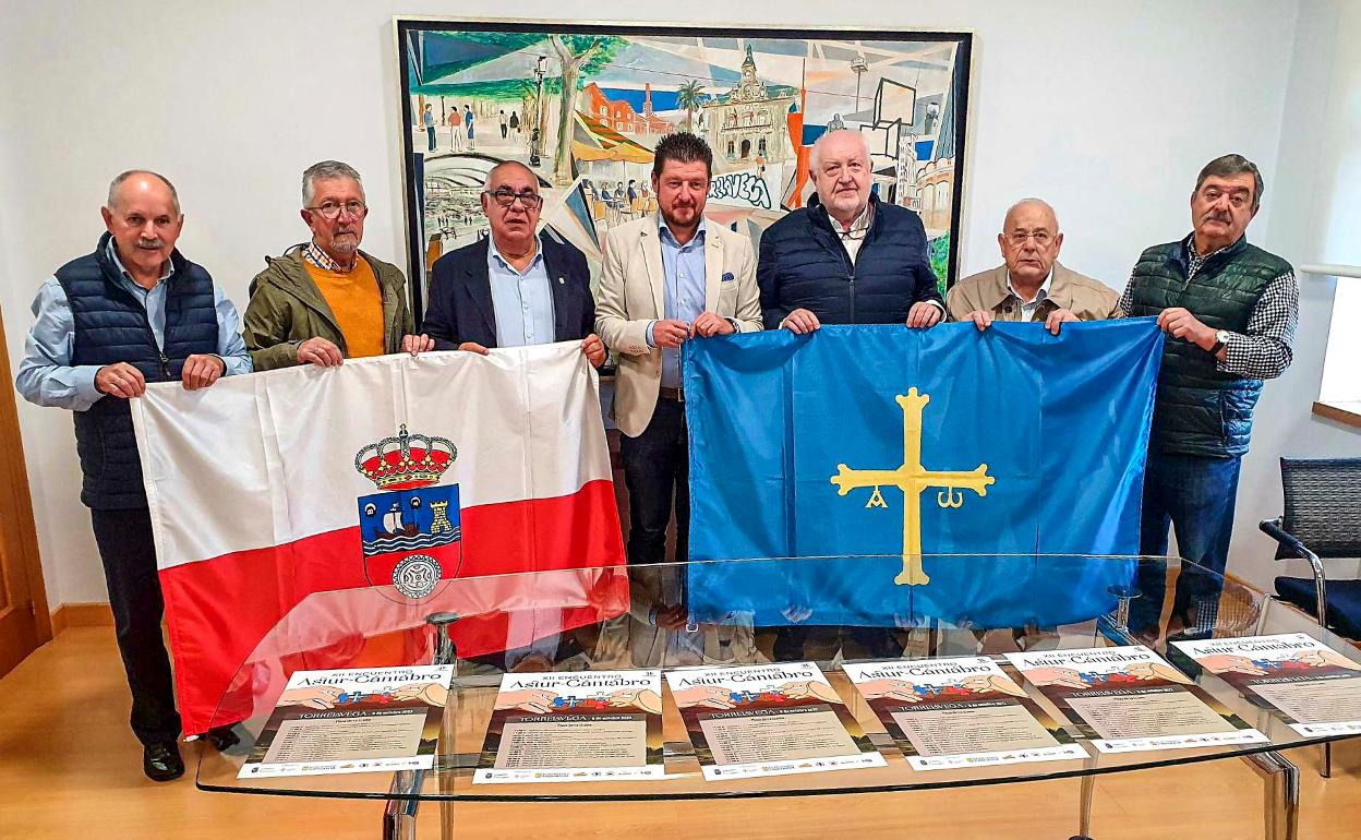 El concejal Jesús Sánchez (en el centro), sostiene la bandera asturiana junto a representantes de las entidades colaboradoras, este viernes, en Torrelavega. 