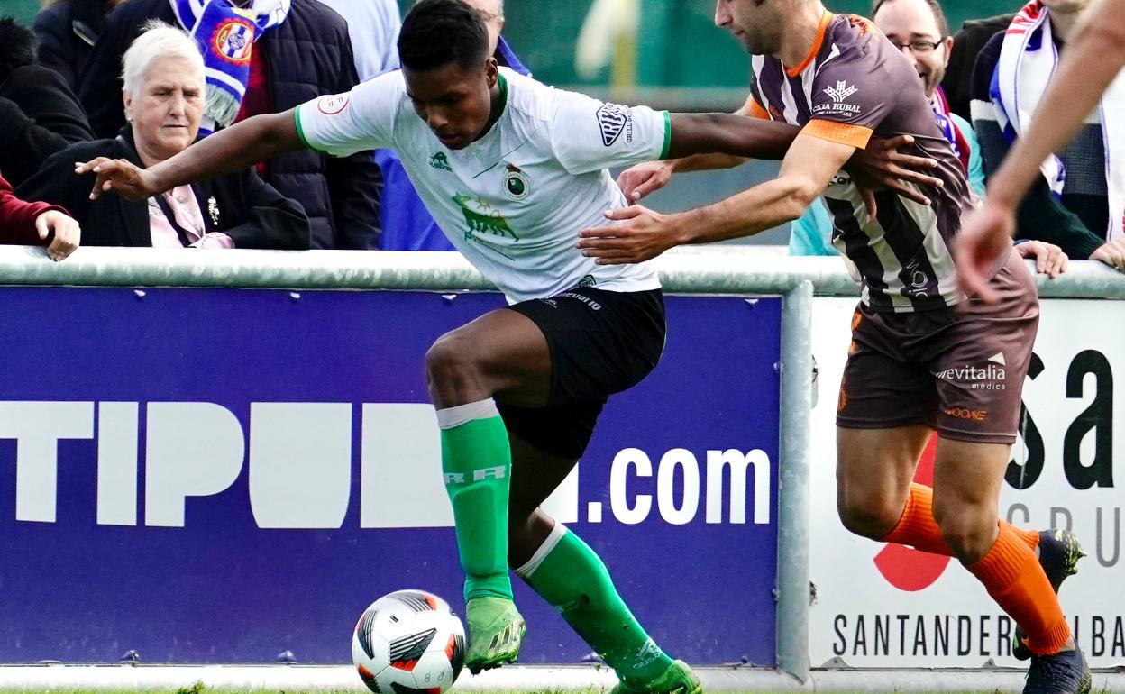 Jeremy controla el balón ante un rival del Avilés en el partido en las Instalaciones Nando Yosu.
