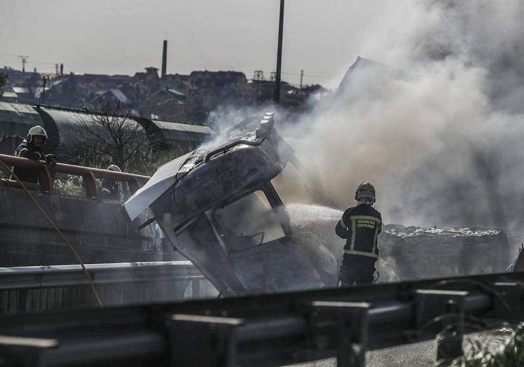 Imagen principal - Rescatan de la cabina en llamas a un camionero que volcó en la A-67