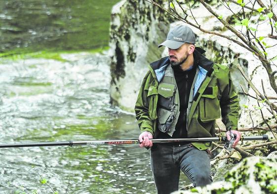 Un pescador echa la caña al río Pas durante el primer día de la campaña salmonera de 2022.