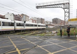 Un tren discurre a su paso por Torrelavega, a la altura de la calle Pablo Garnica.