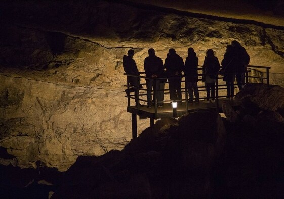 Un grupo de personas visita la cueva de El Pendo.