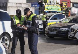 Agentes de la Policía Local de Santander, consultan documentación.