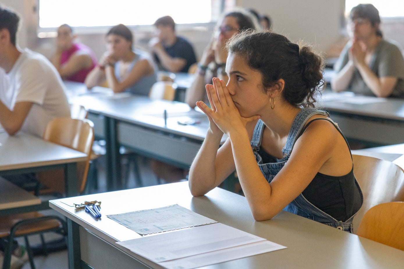 Una de las alumnas presta atención a las instrucciones del profesorado sobre la dinámica del examen.