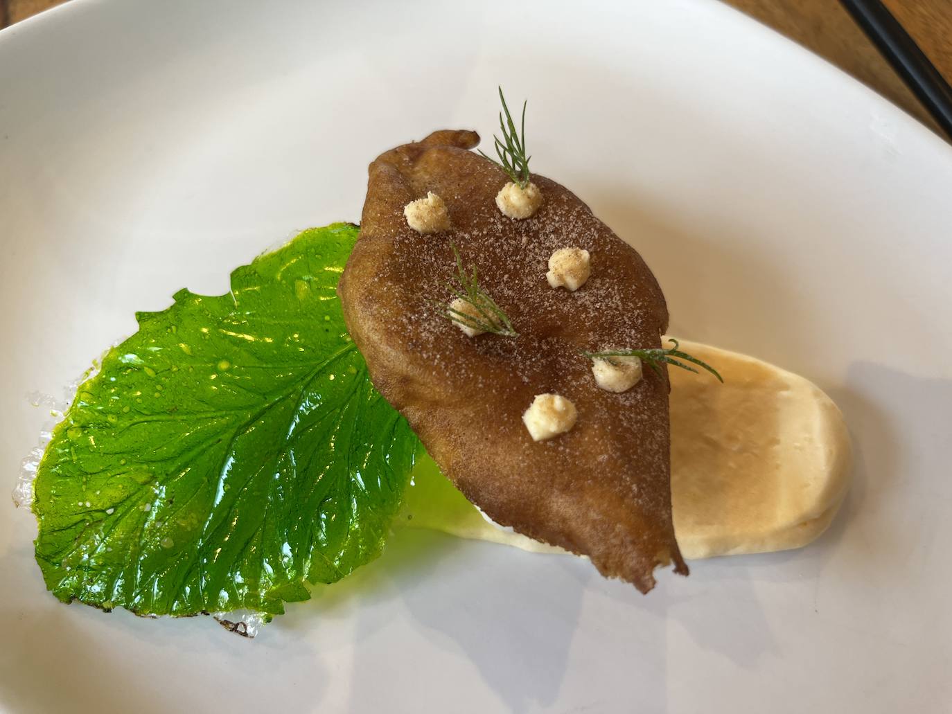 Paparajote de hoja comestible sobre crema de limón.