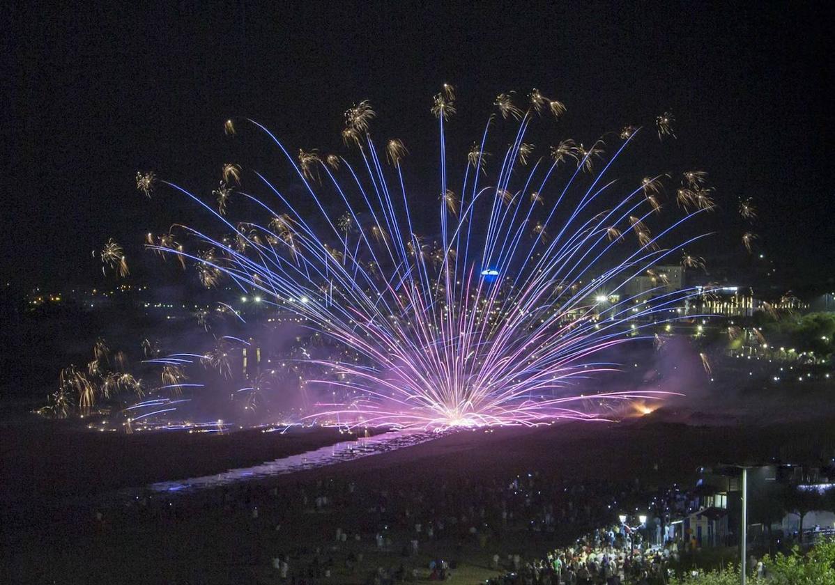 LA FOTO DEL MES DE JULIO: El cielo se ilumina y deja ver, si se ha elegido un buen lugar, las siluetas recortadas de miles de personas que miran al lugar donde se mezclan mar y firmamento. Para el santanderino y para el que visita la ciudad es la noche que queda en la retina al repasar el álbum personal de cada verano. La gran (y larga) noche.