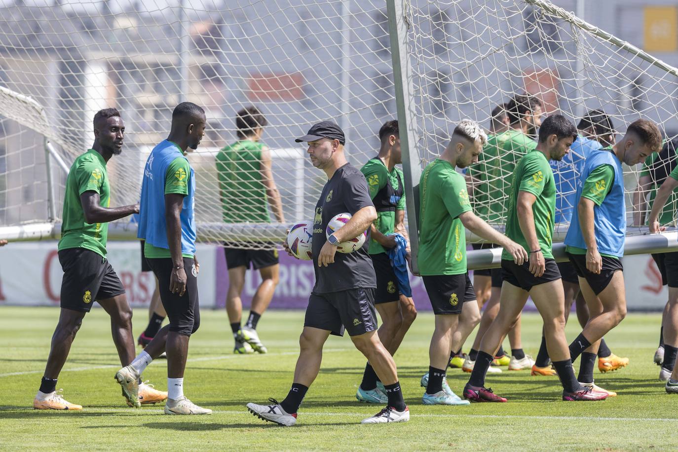 José Alberto, en La Albericia, mientras sus futbolistas cargan una portería. 