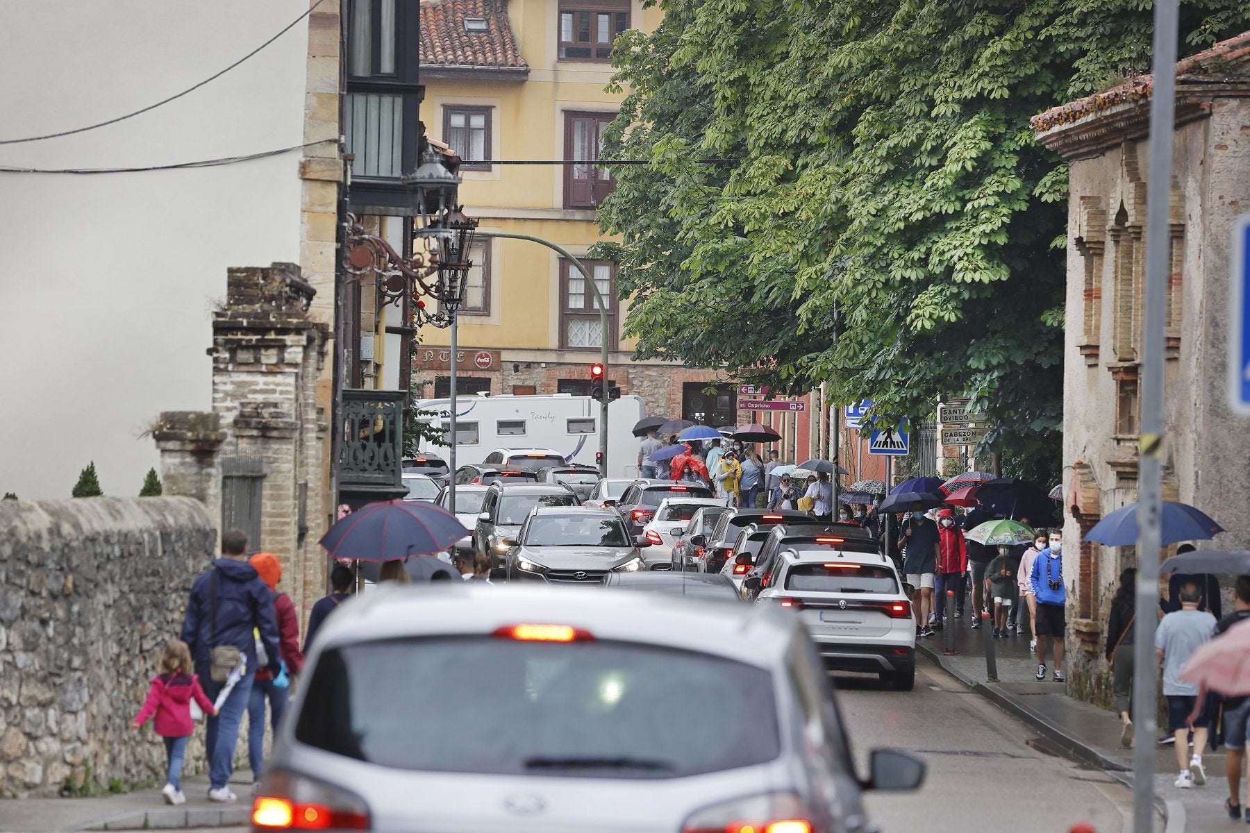 Una de las calles del centro de la villa atestada de vehículos y peatones en verano.