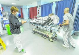 Dos sanitarios atienden a una persona trasladada en camilla en el Servicio de Urgencias del Hospital Valdecilla, en Santander.
