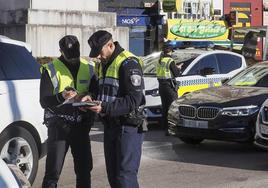 Agentes de la Policía Local de Santander, consultando documentación.