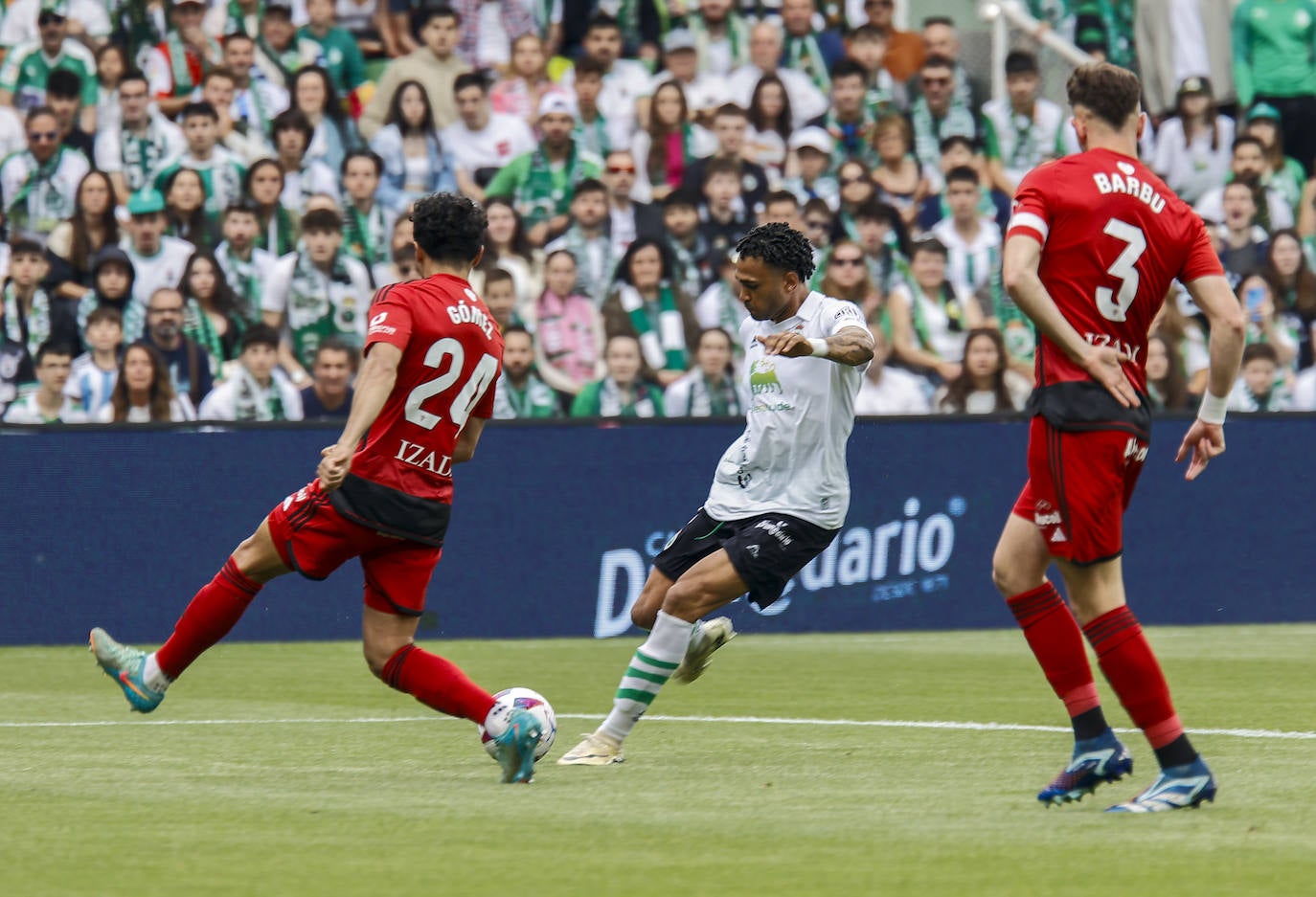 Mboula se dispone a golpear el balón ante Gómez y Barbu.