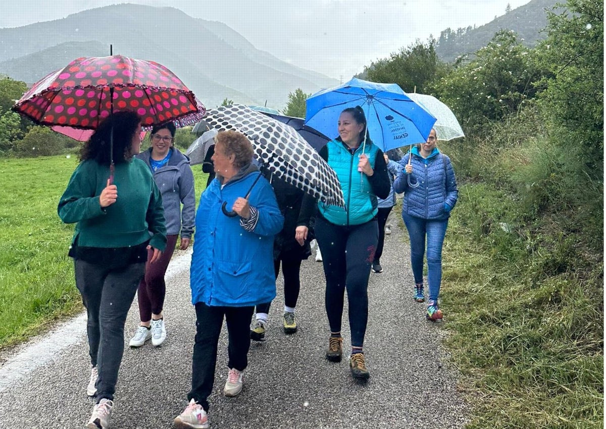 Imagen secundaria 1 - Grupo de participantes al finalizar la actividad; paseo por el campo y un vecino de Potes se toma la tensión