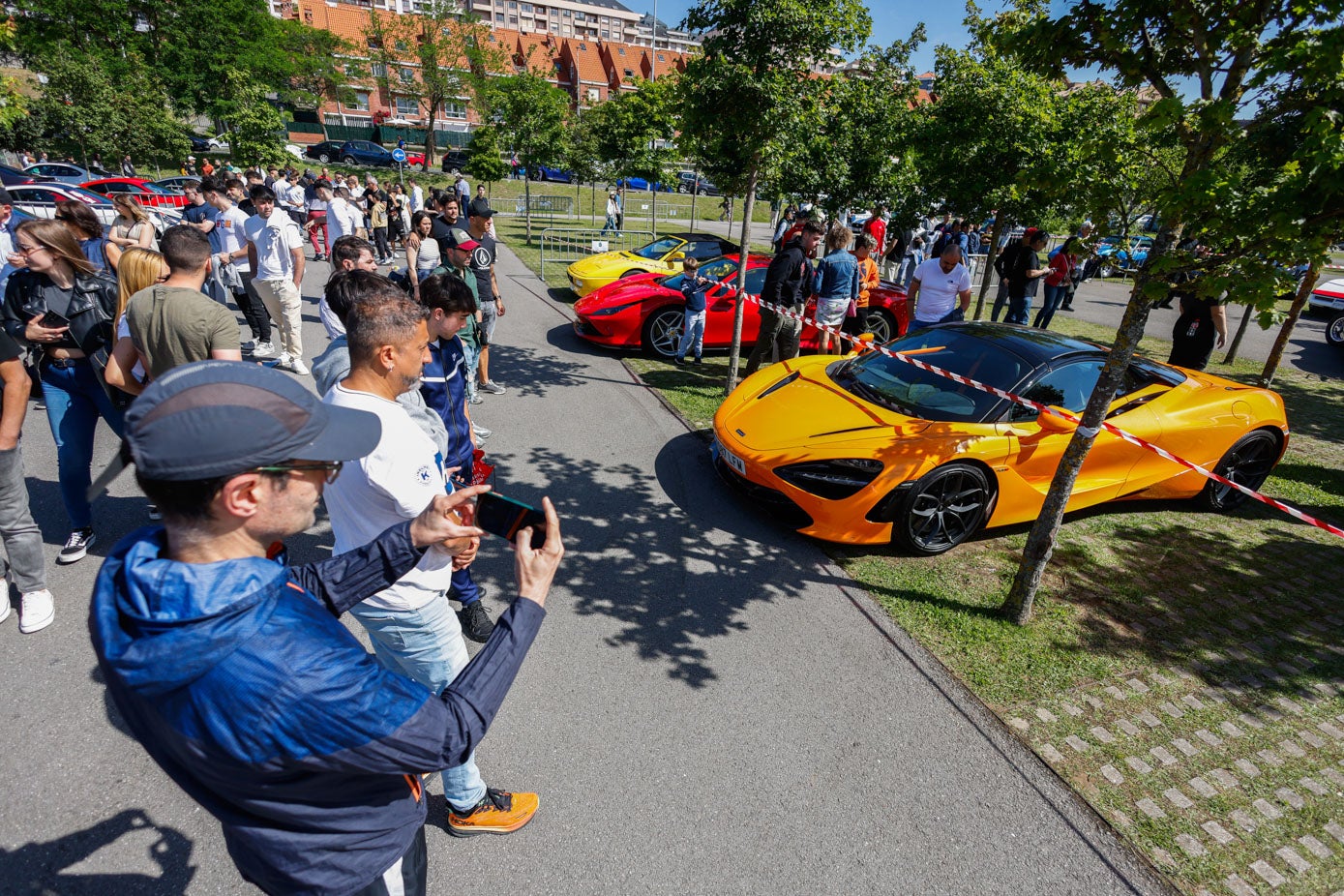 Varias personas hacen fotos a uno de los McLaren.