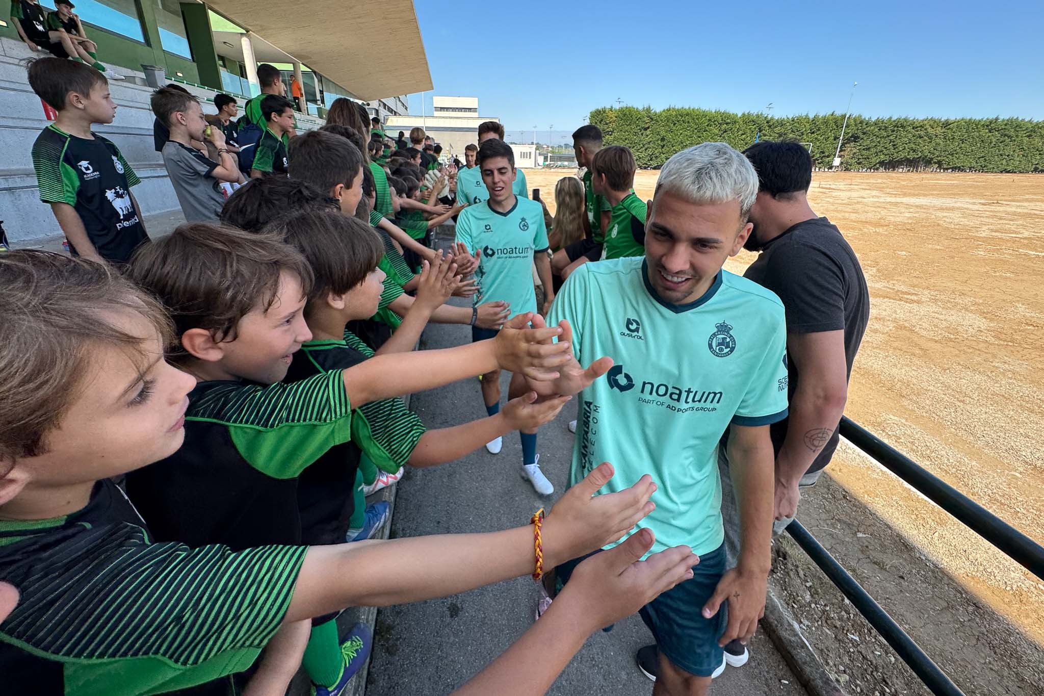 Arana, seguido de Íñigo Sainz-Maza, choca su mano con las de los alumnos del campus.