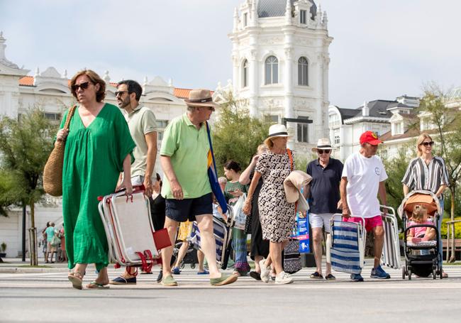 Un grupo de turistas dirigiéndose a los arenales de El Sardinero este verano