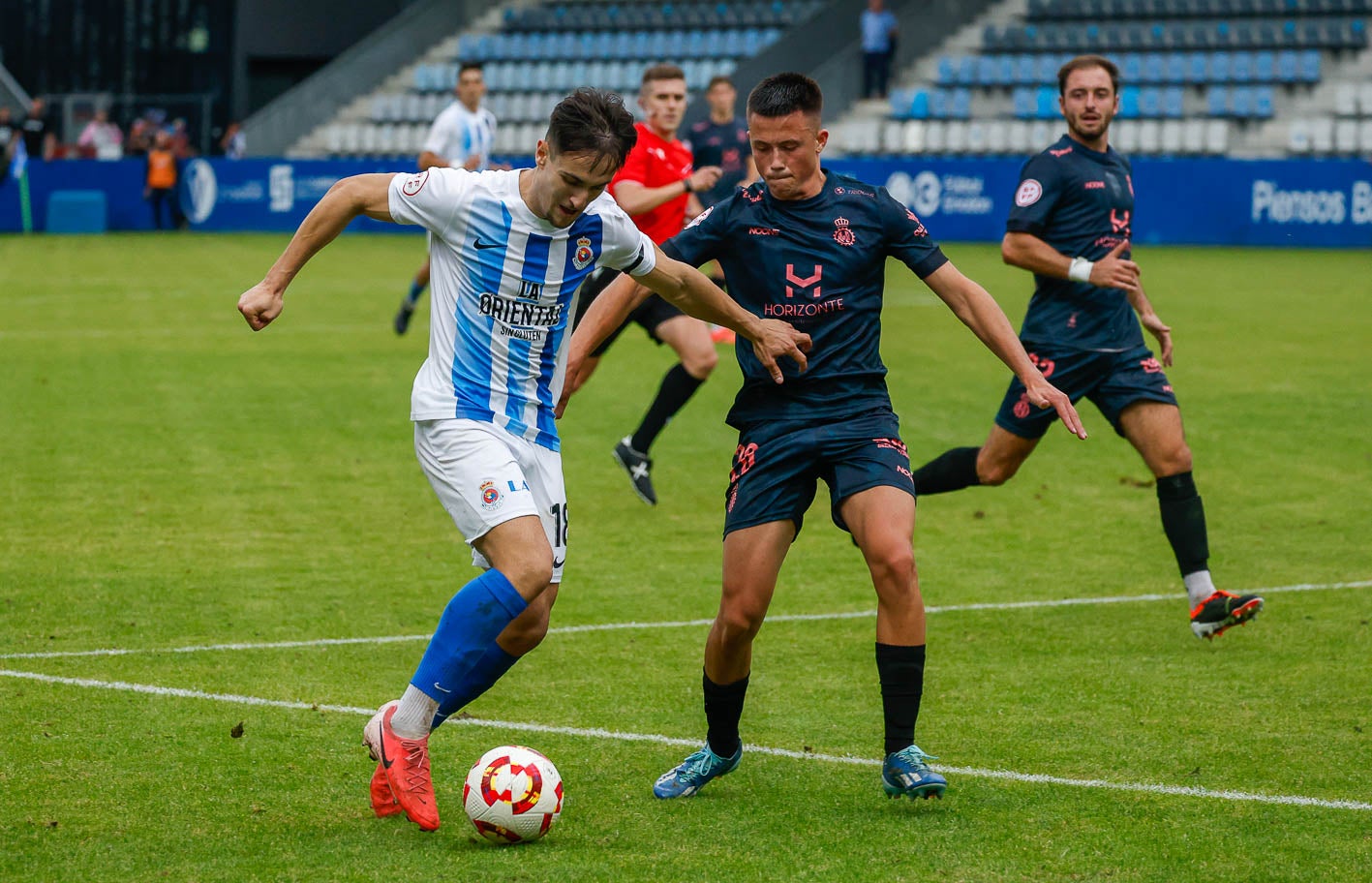 Chus Ruiz conduce el balón ante un rival del Avilés. 